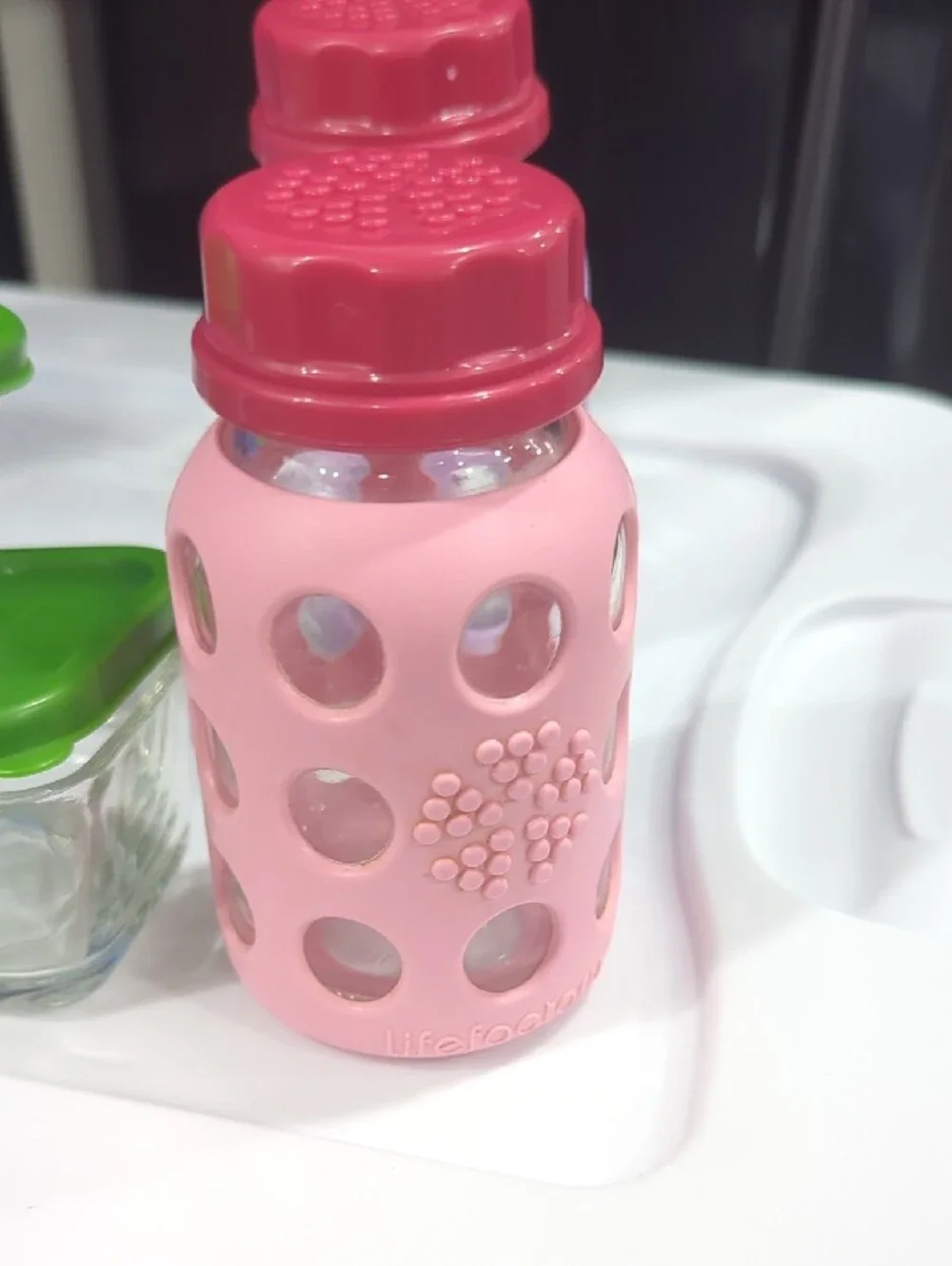Glass Food Storage Set with Green Lids and Assorted Silicone Bottles